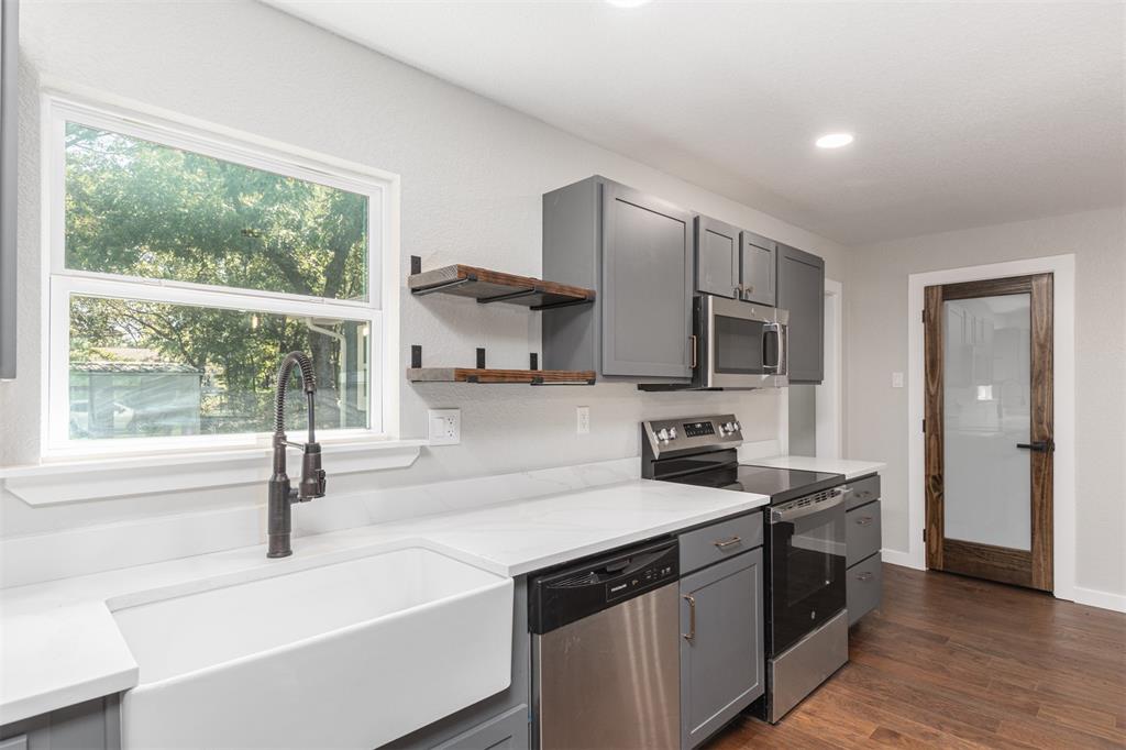 1024 Tower Street Canton, TX 75103 - Photo 7 of 27 a kitchen with stainless steel appliances granite countertop a sink stove and refrigerator