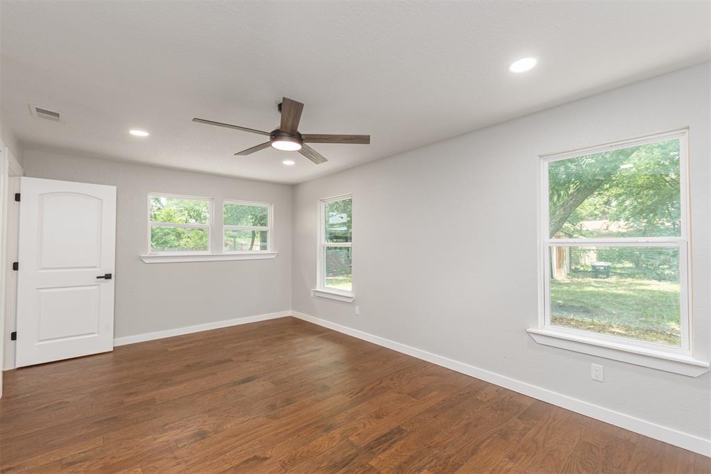 1024 Tower Street Canton, TX 75103 - Photo 9 of 27 an empty room with wooden floor and windows