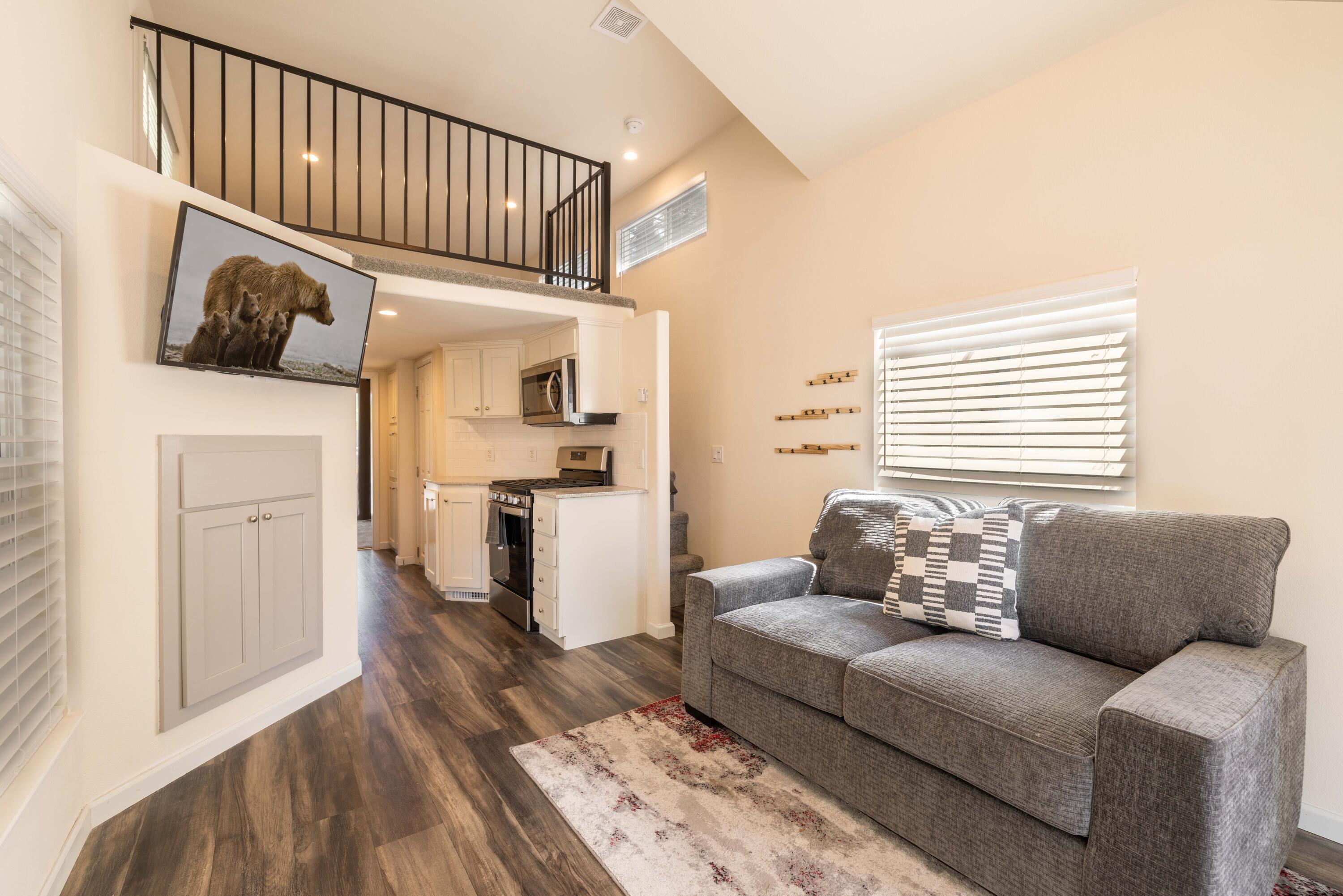 a living room with furniture or kitchen and a wooden floor