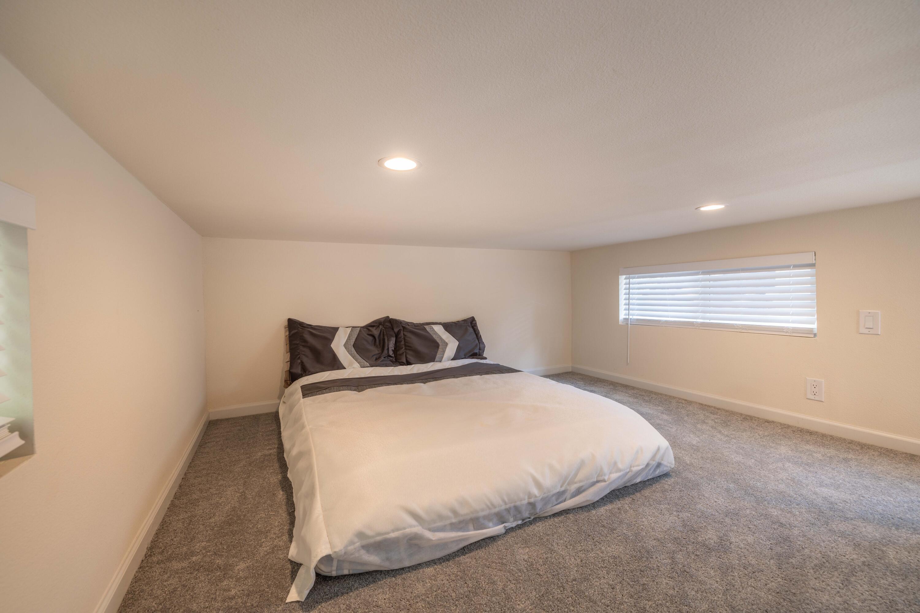 547 Alden Road, Unit RV4 Big Bear Lake, CA 92315 - Photo 14 of 38 a bed sitting in a bedroom next to a window