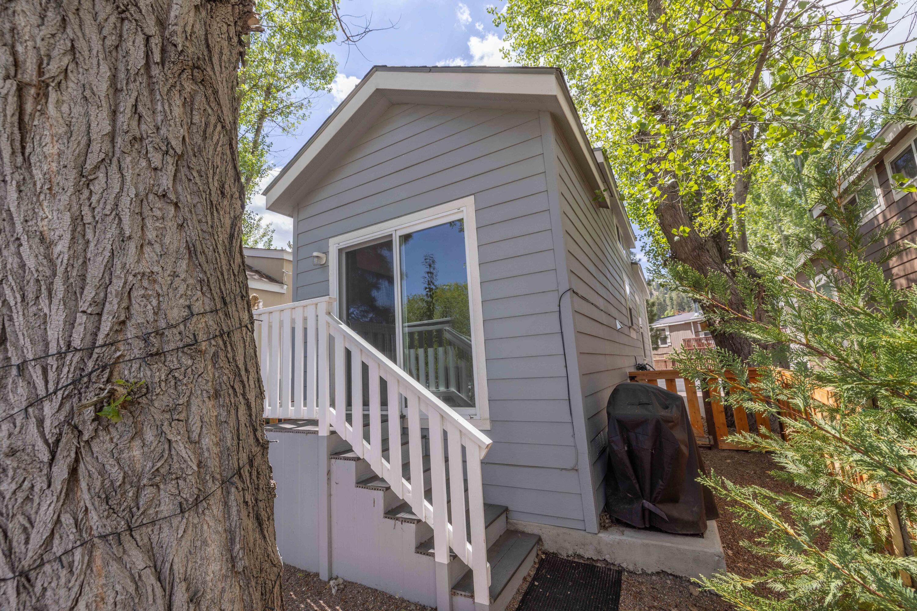 547 Alden Road, Unit RV4 Big Bear Lake, CA 92315 - Photo 19 of 38 a view of a house with a small yard and wooden fence