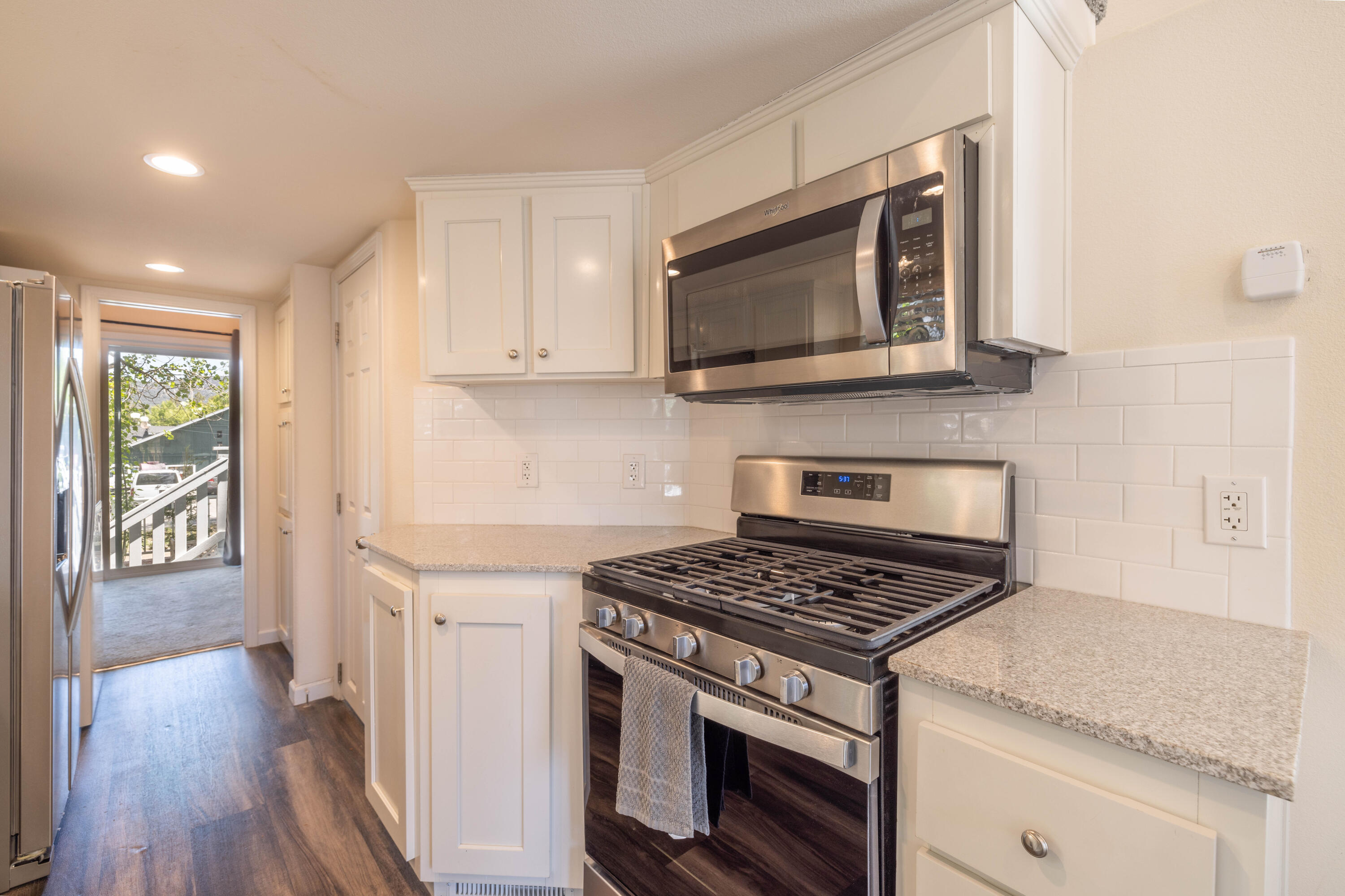 547 Alden Road, Unit RV4 Big Bear Lake, CA 92315 - Photo 10 of 38 a kitchen with stainless steel appliances granite countertop a stove and a microwave