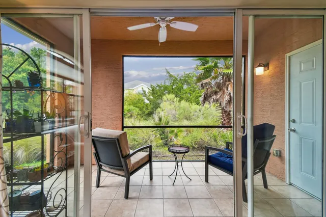 a balcony with table and chairs