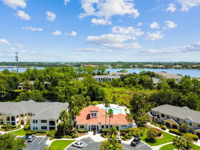 a living room with furniture a rug and a large window