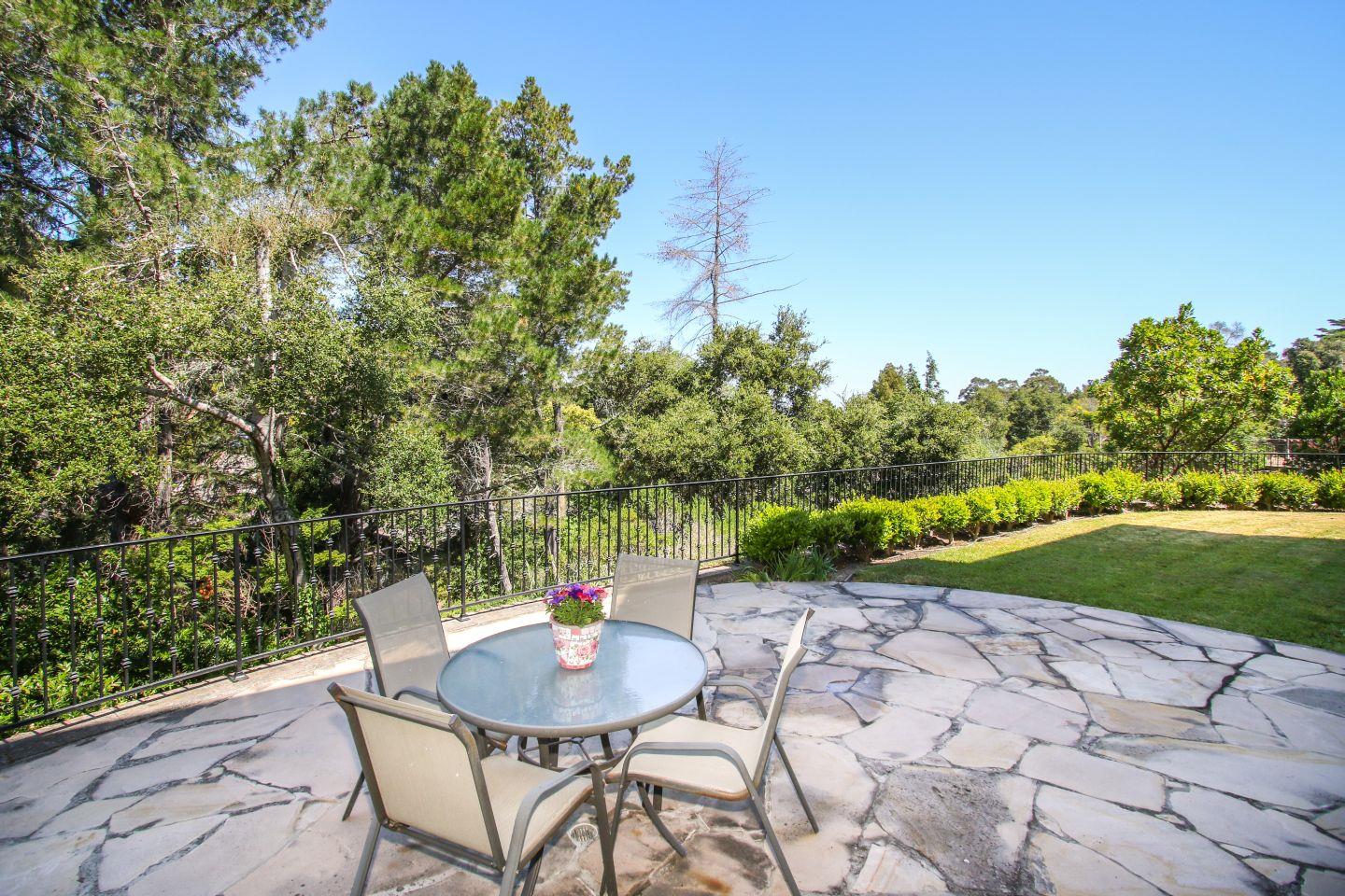 640 Pullman Road Hillsborough, CA 94010 - Photo 25 of 25 a backyard of a house with table and chairs