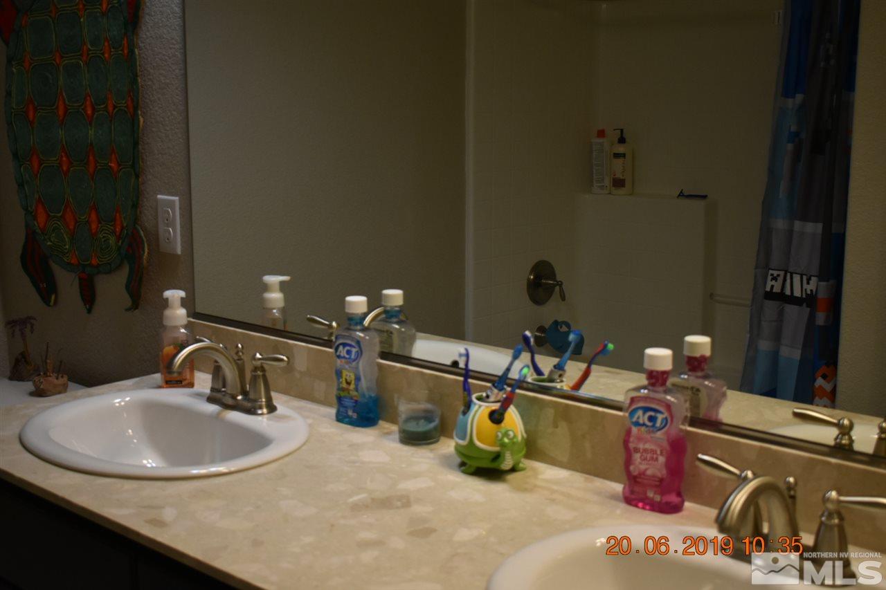 10836 Walnut Ridge Drive Reno, NV 89521 - Photo 18 of 25 a bathroom with a sink and a mirror