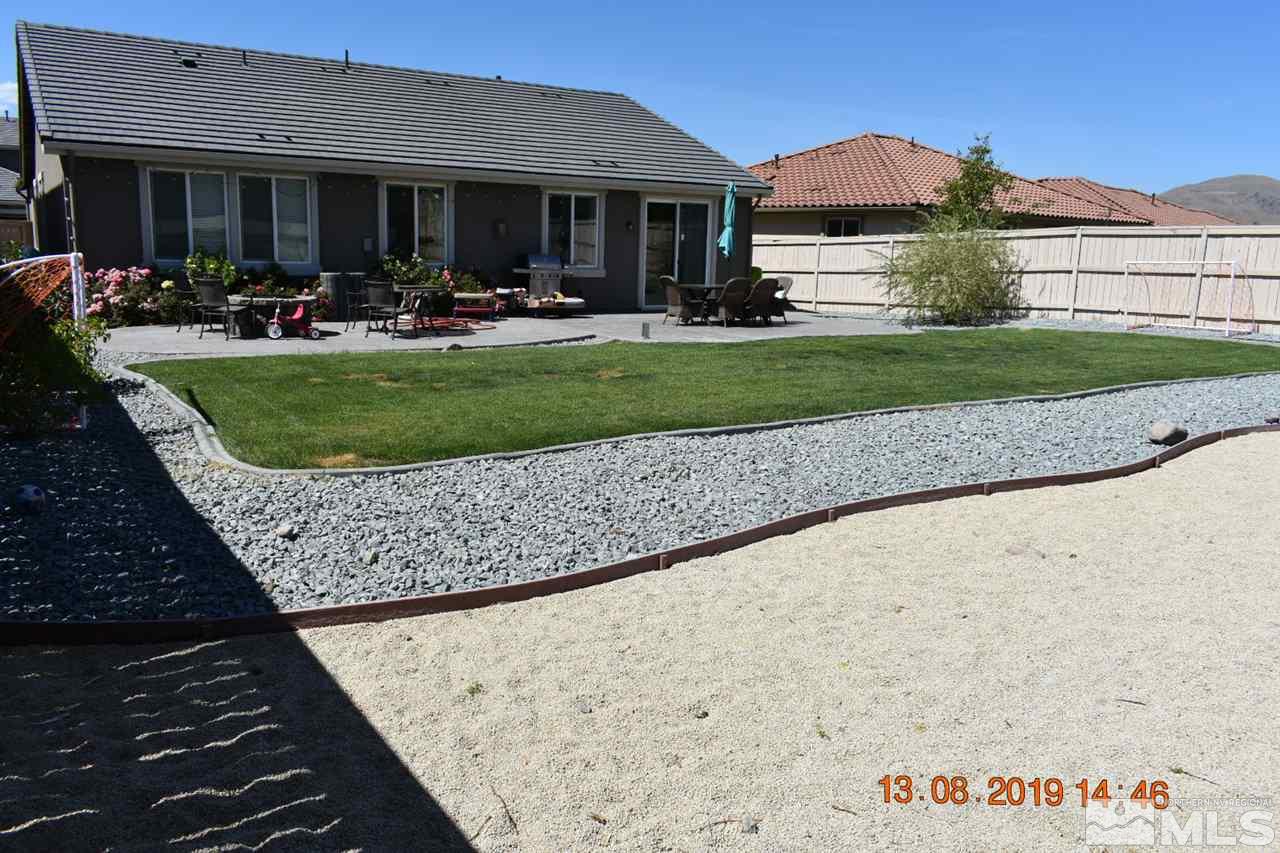 10836 Walnut Ridge Drive Reno, NV 89521 - Photo 19 of 25 a front view of a house with a yard patio and fire pit