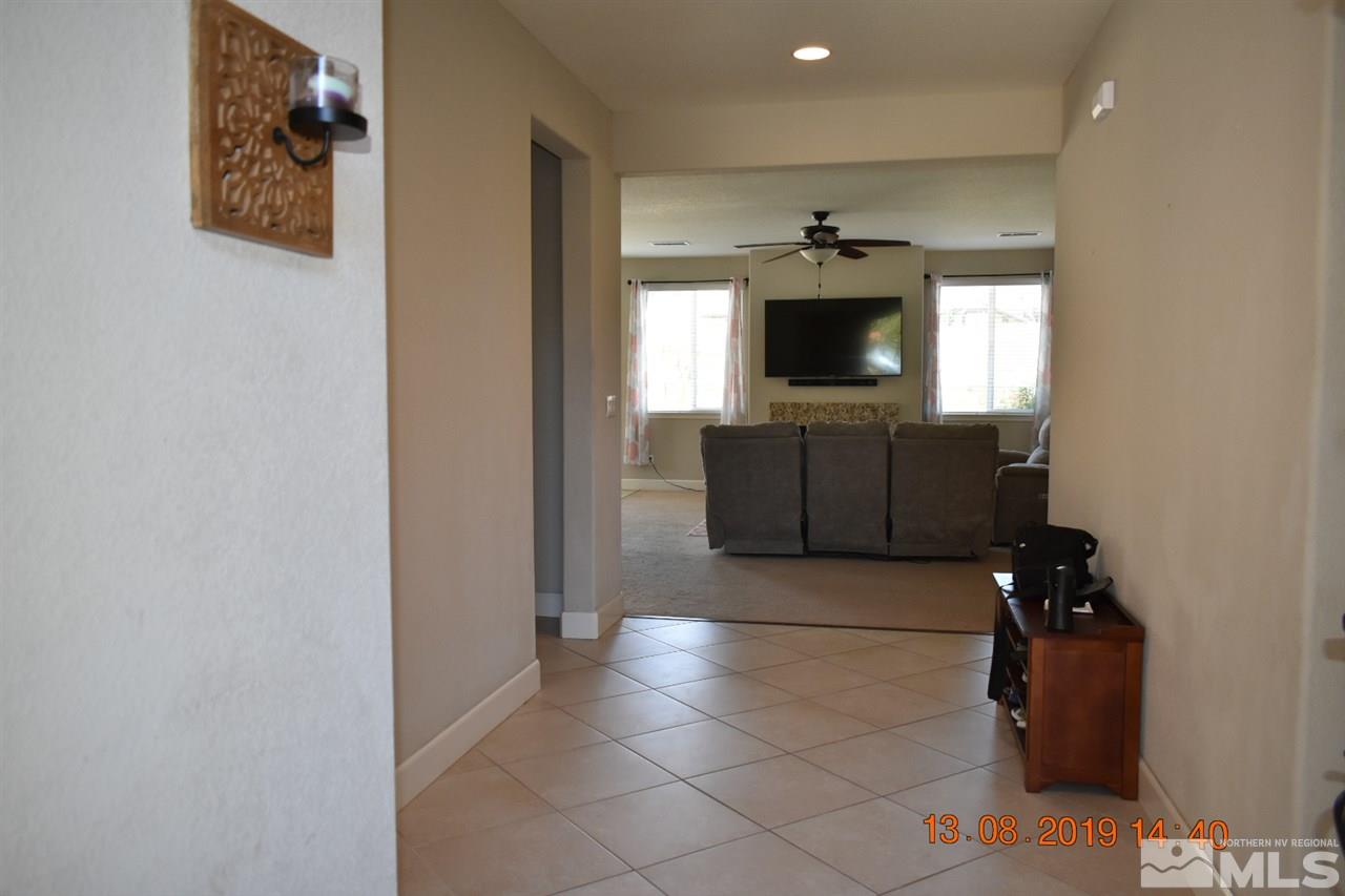 10836 Walnut Ridge Drive Reno, NV 89521 - Photo 2 of 25 a living room with furniture and a flat screen tv