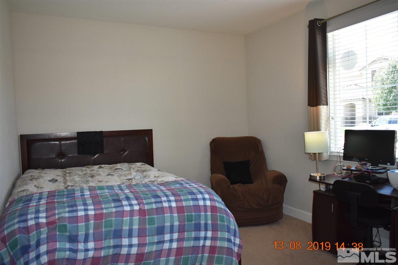 10836 Walnut Ridge Drive Reno, NV 89521 - Photo 24 of 25 a bedroom with a bed and a chair