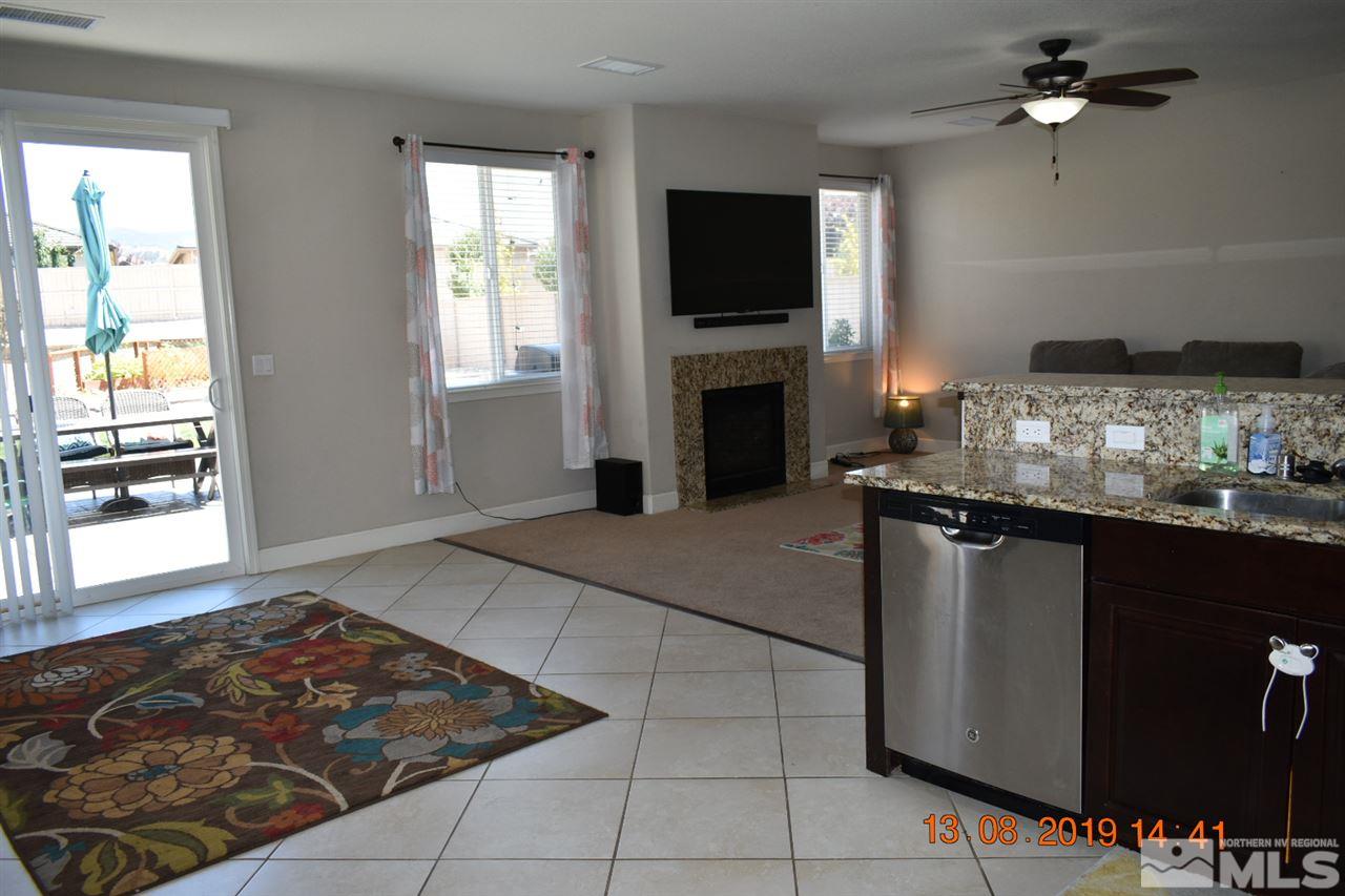 10836 Walnut Ridge Drive Reno, NV 89521 - Photo 3 of 25 a kitchen with granite countertop a stove a sink and a microwave