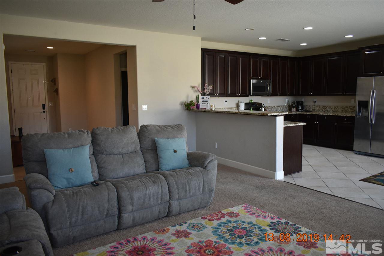 10836 Walnut Ridge Drive Reno, NV 89521 - Photo 5 of 25 a living room with stainless steel appliances kitchen island granite countertop furniture and a kitchen view