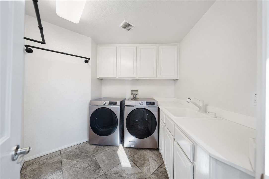 31465 Inverness Court Temecula, CA 92591 - Photo 31 of 75 Dedicated laundry room provides generous space and convenient storage for every day living.