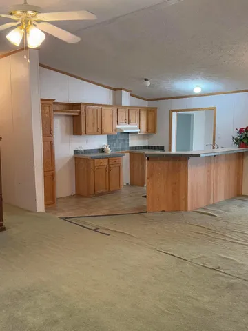 a kitchen with stainless steel appliances a sink a refrigerator and a cabinets