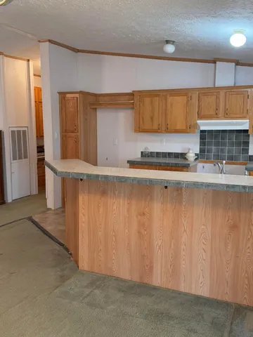 a kitchen with stainless steel appliances granite countertop a sink and cabinets