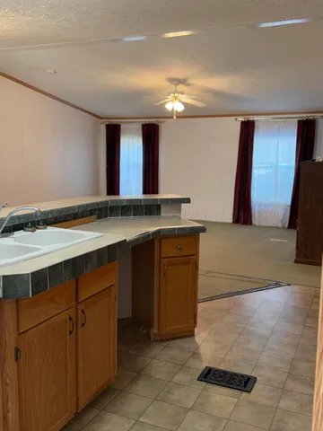 a kitchen with stainless steel appliances granite countertop a refrigerator and a stove