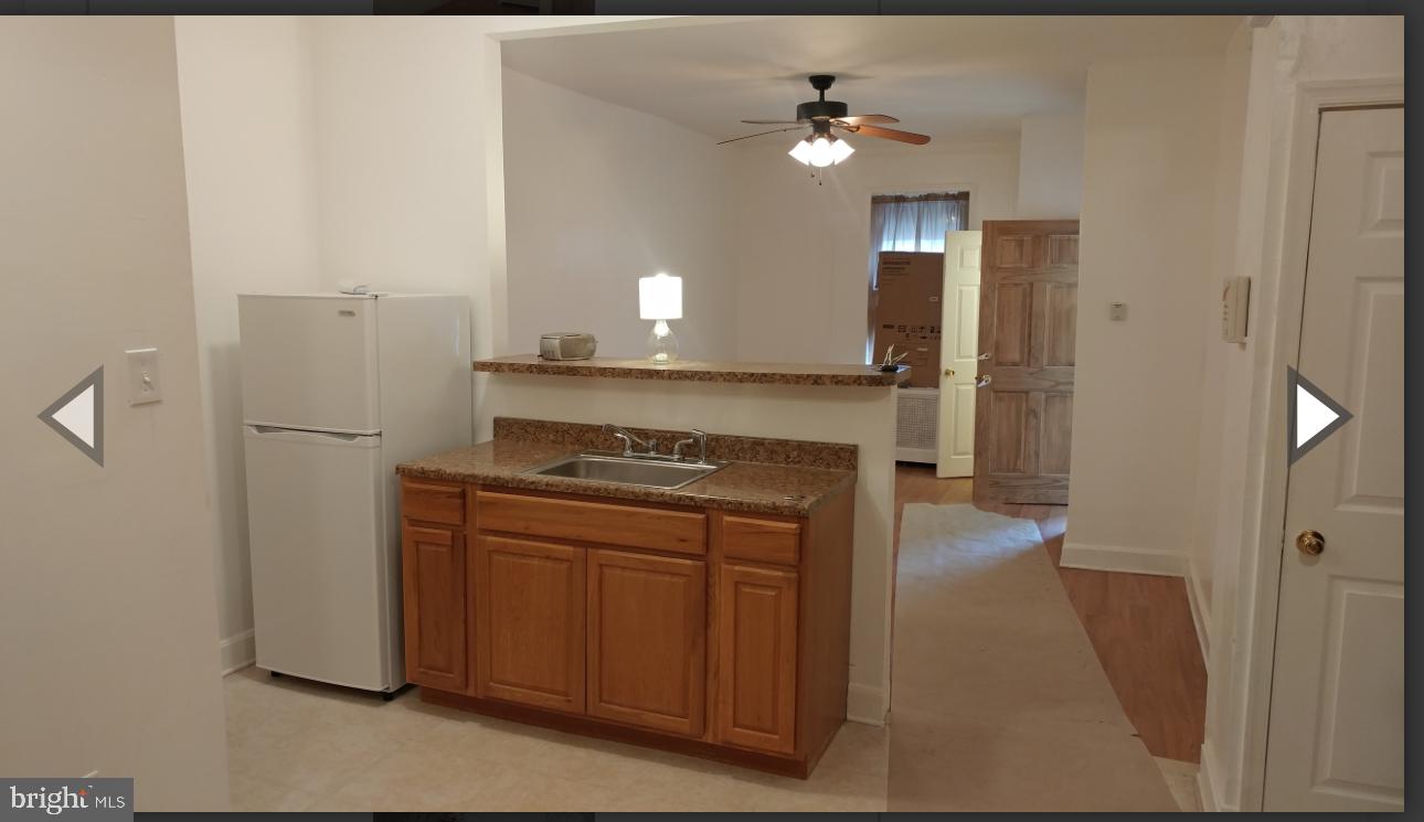 530 West Ritner Street Philadelphia, PA 19148 - Photo 9 of 11 a kitchen with stainless steel appliances granite countertop a refrigerator a stove and a sink