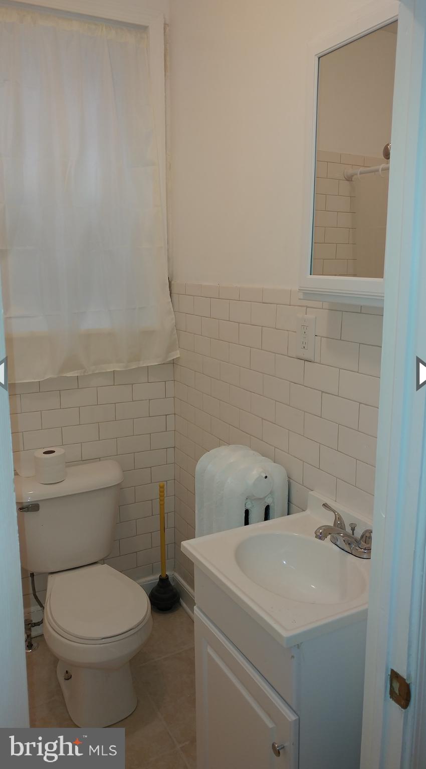 530 West Ritner Street Philadelphia, PA 19148 - Photo 10 of 11 a bathroom with a toilet sink and mirror