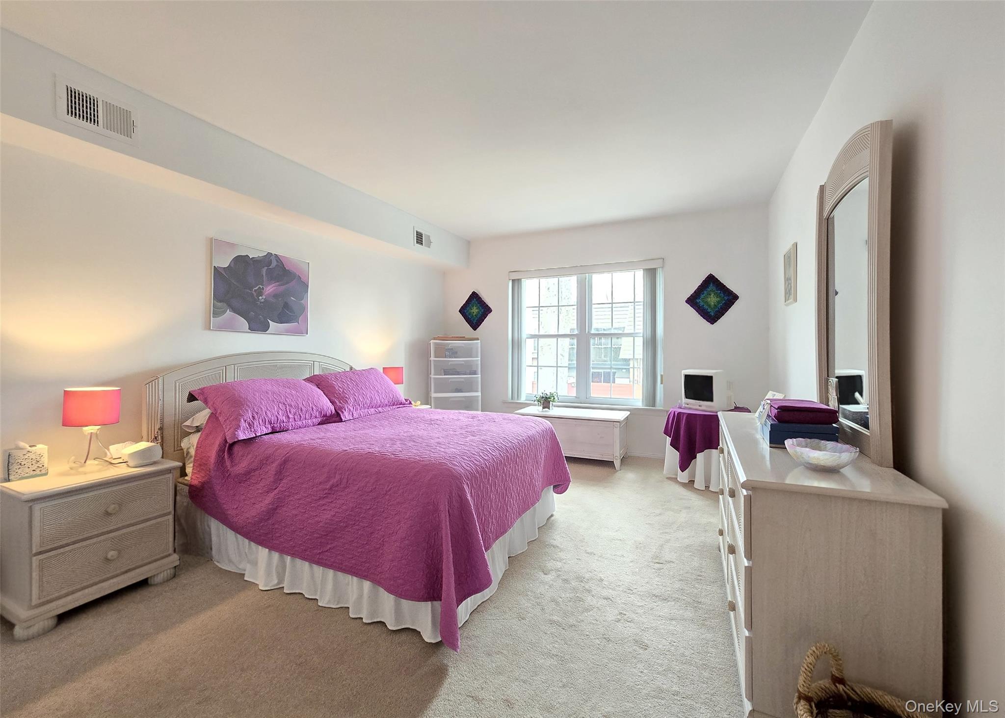 655 Middle Country Road, Unit 22E2 Coram, NY 11727 - Photo 11 of 16 a bedroom with a bed and a window