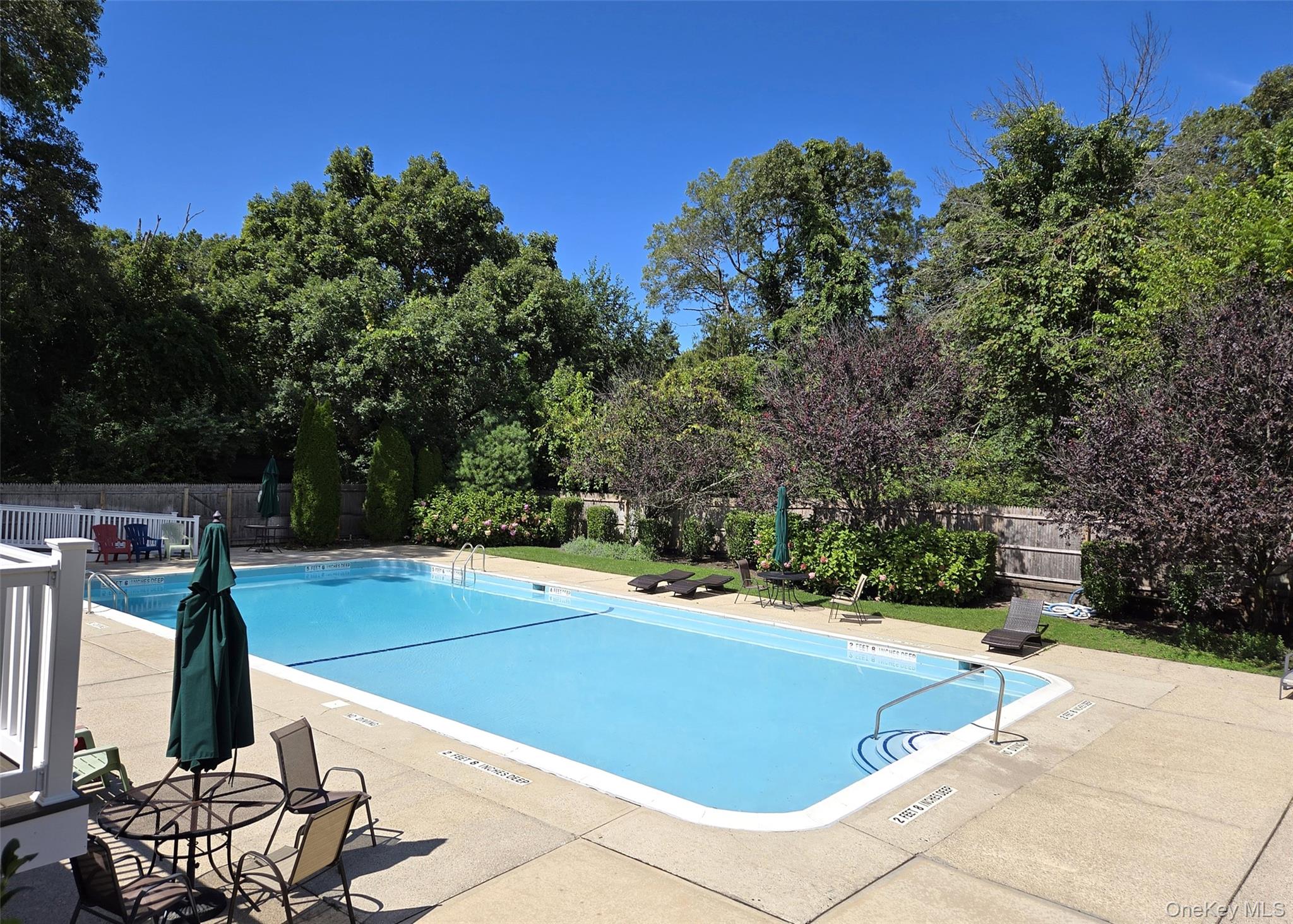 655 Middle Country Road, Unit 22E2 Coram, NY 11727 - Photo 14 of 16 a view of a swimming pool with a patio and a yard