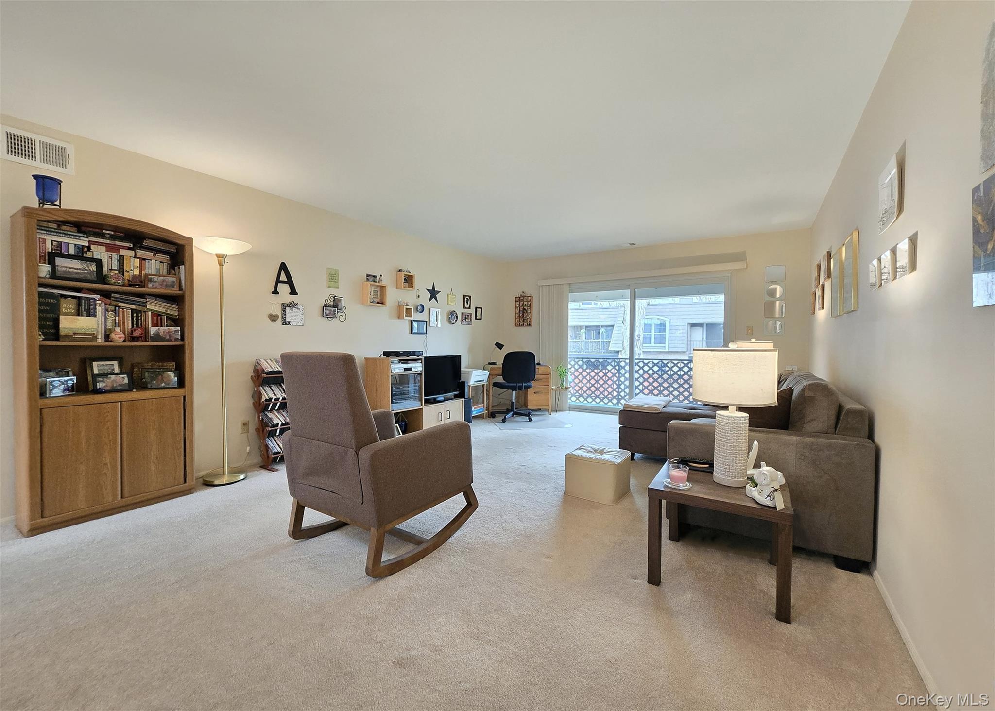 655 Middle Country Road, Unit 22E2 Coram, NY 11727 - Photo 4 of 16 a living room with furniture and wooden floor