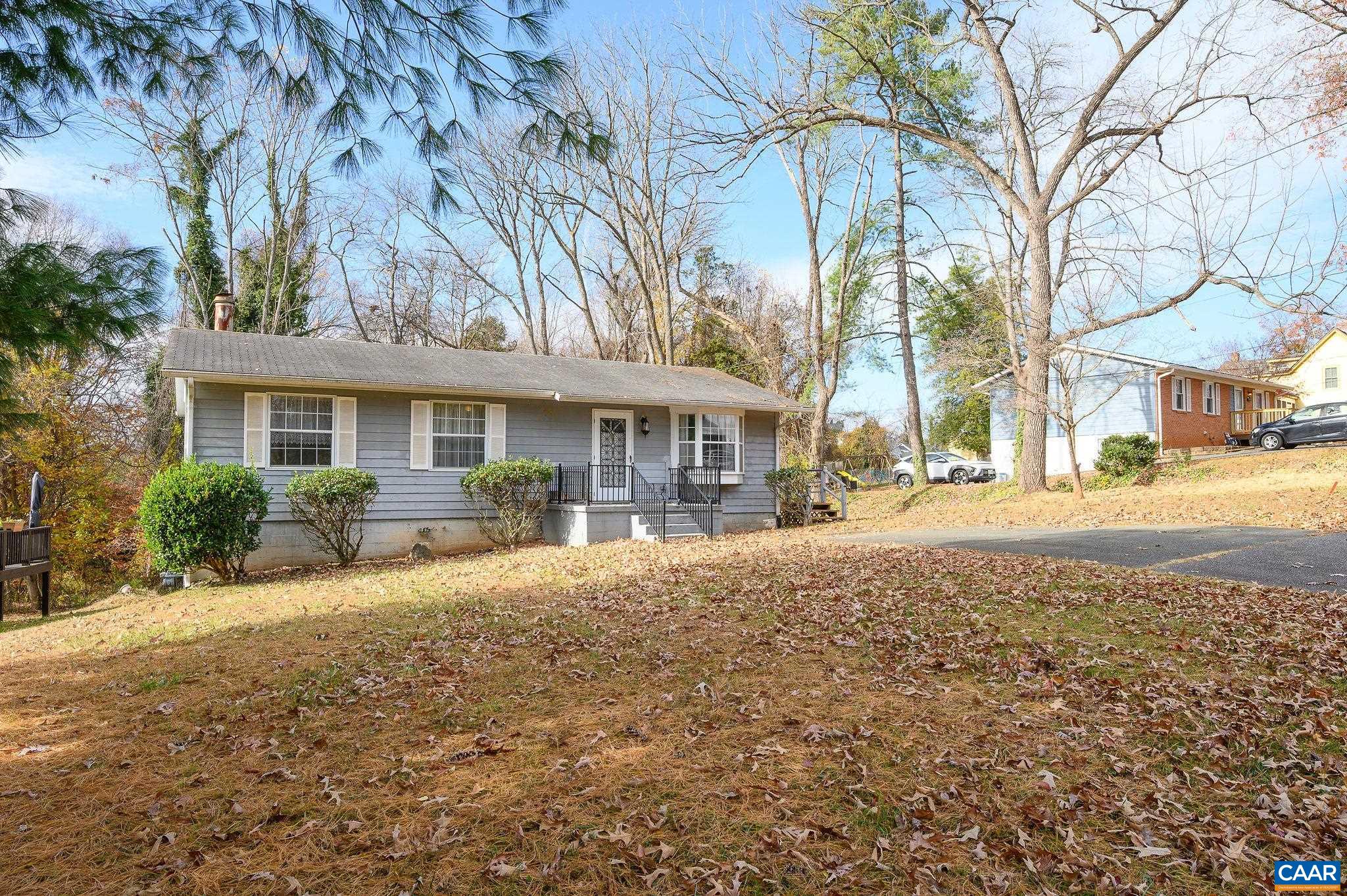 202 Hartmans Mill Road Charlottesville, VA 22902 - Photo 2 of 27 a front view of a house with a yard and large trees