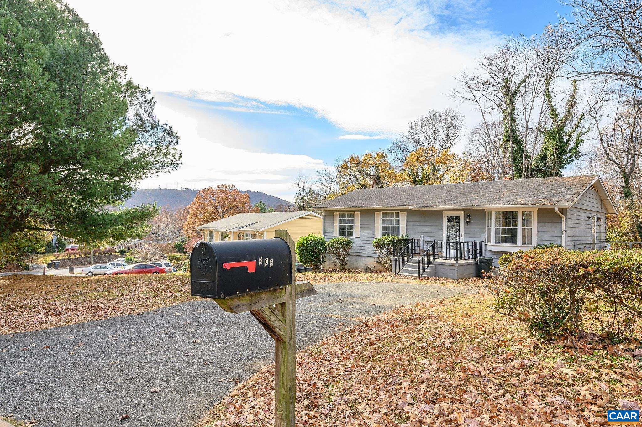 202 Hartmans Mill Road Charlottesville, VA 22902 - Photo 4 of 27 a front view of a house with a yard