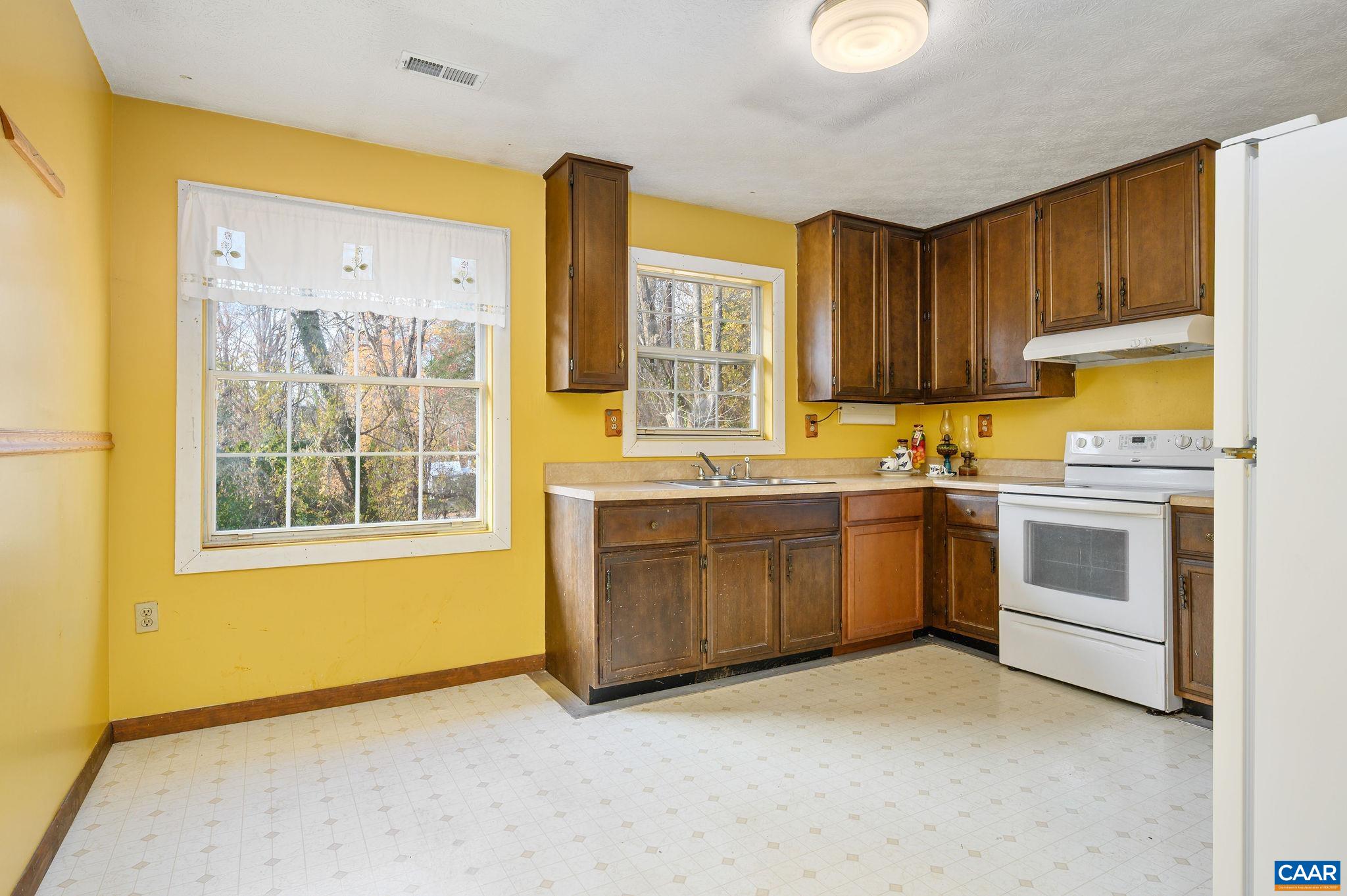 202 Hartmans Mill Road Charlottesville, VA 22902 - Photo 8 of 27 a kitchen with a stove a sink and a window
