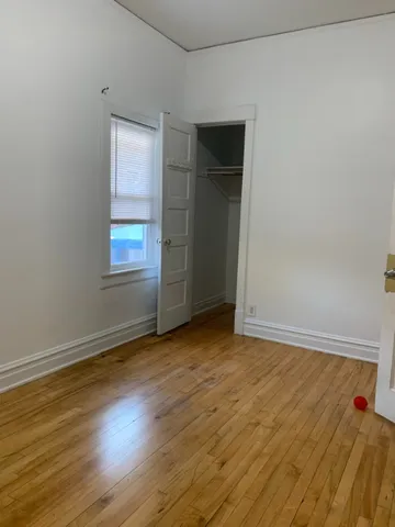 a view of an empty room and wooden floor