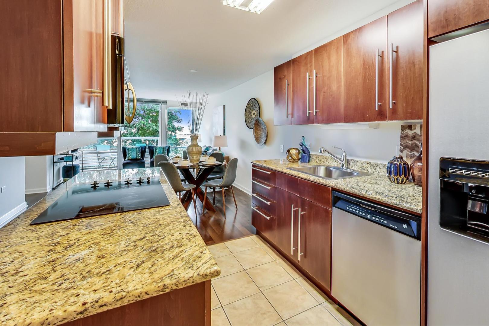 800 Elgin Road, Unit 702 Evanston, IL 60201 - Photo 7 of 16 a kitchen with sink cabinets and stove