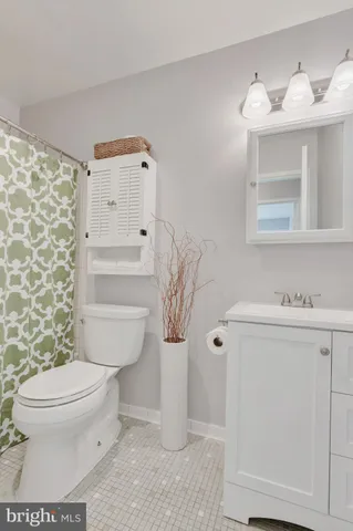 a bathroom with a toilet sink and shower