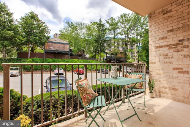 a view of a chairs and table in the balcony