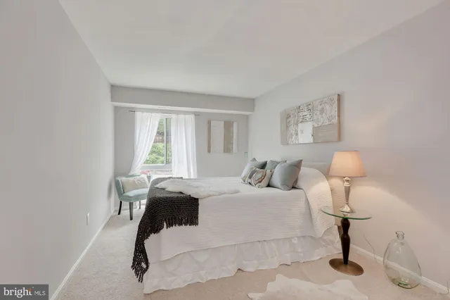 a bedroom with a bed and a table in it