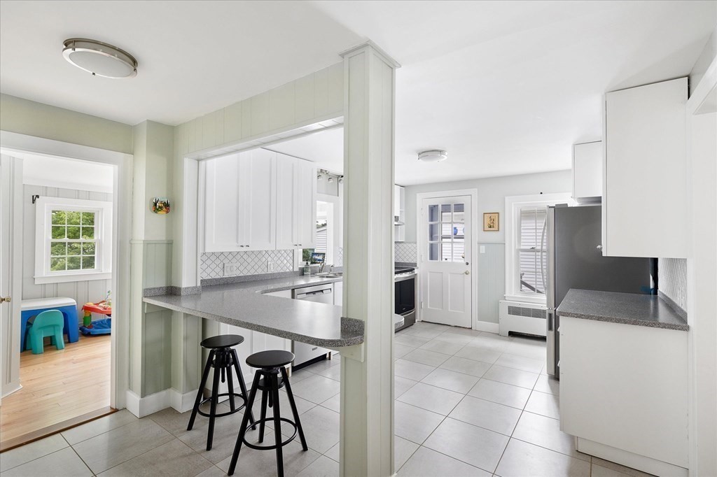 5 West Sutton Road Sutton, MA 01590 - Photo 7 of 36 a kitchen with stainless steel appliances kitchen island granite countertop a refrigerator and a stove top oven