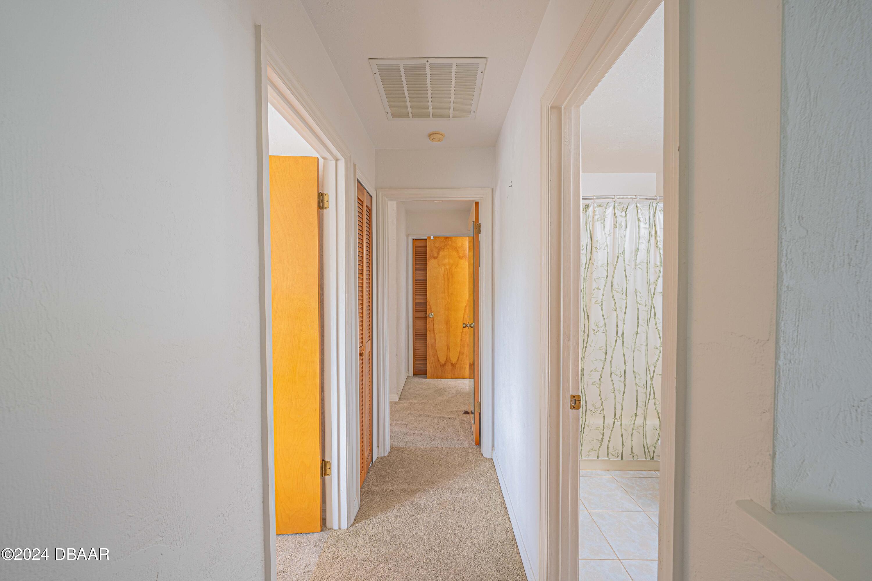 42 Jana Drive Ponce Inlet, FL 32127 - Photo 22 of 34 a view of a hallway with windows