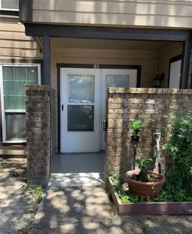 a front view of a house with plants