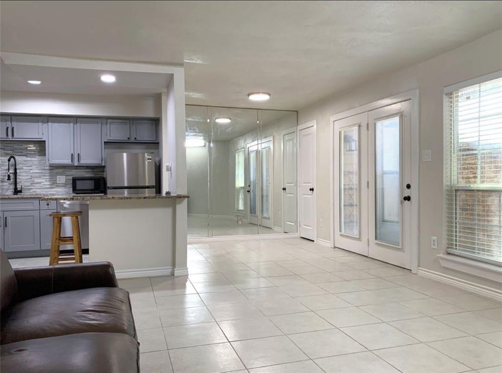 9803 Walnut Street, Unit 107 Dallas, TX 75243 - Photo 6 of 10 a view of a kitchen with a sink and dishwasher a refrigerator with white cabinets