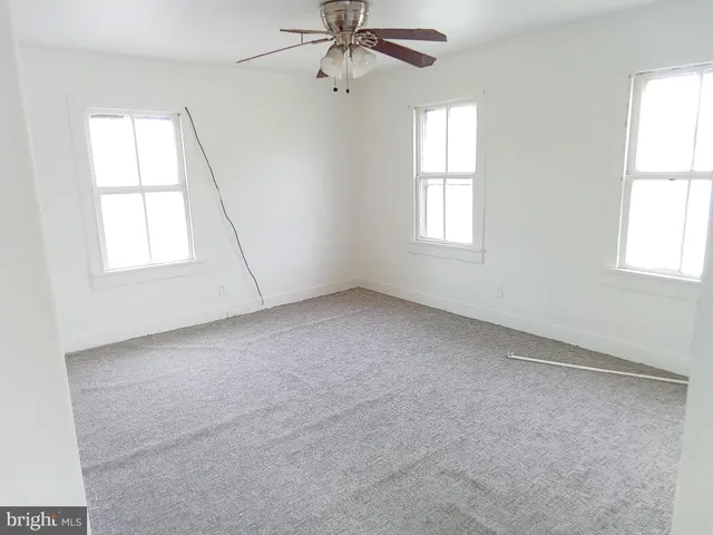 an empty room with windows and closet
