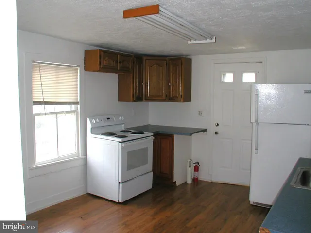 a kitchen with a stove and a refrigerator