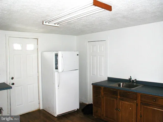 a kitchen with a refrigerator and cabinets