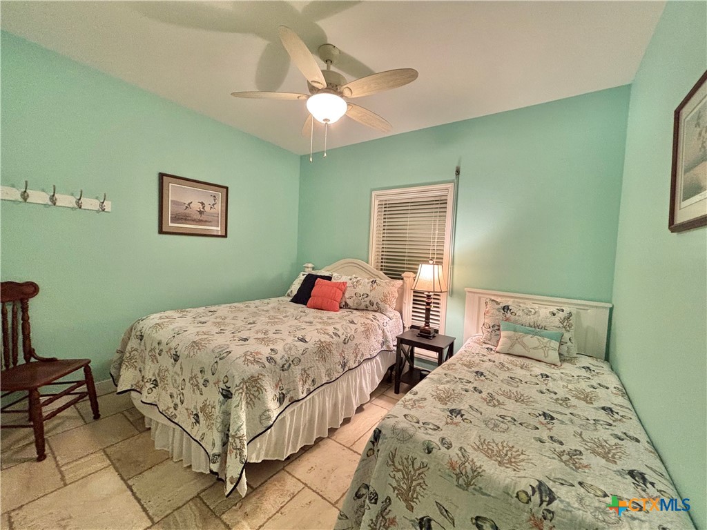 403 Maple Street Port O'Connor, TX 77982 - Photo 17 of 48 a bedroom with bed and a window