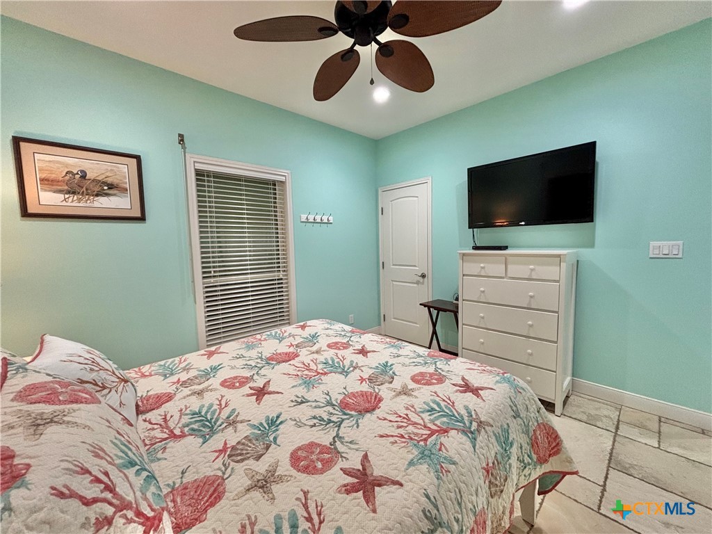 403 Maple Street Port O'Connor, TX 77982 - Photo 23 of 48 a bedroom with a bed and a flat screen tv