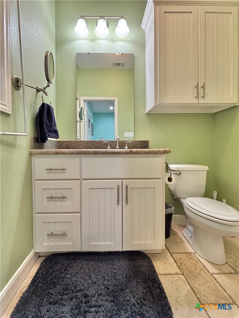 403 Maple Street Port O'Connor, TX 77982 - Photo 26 of 48 a bathroom with a toilet sink and mirror