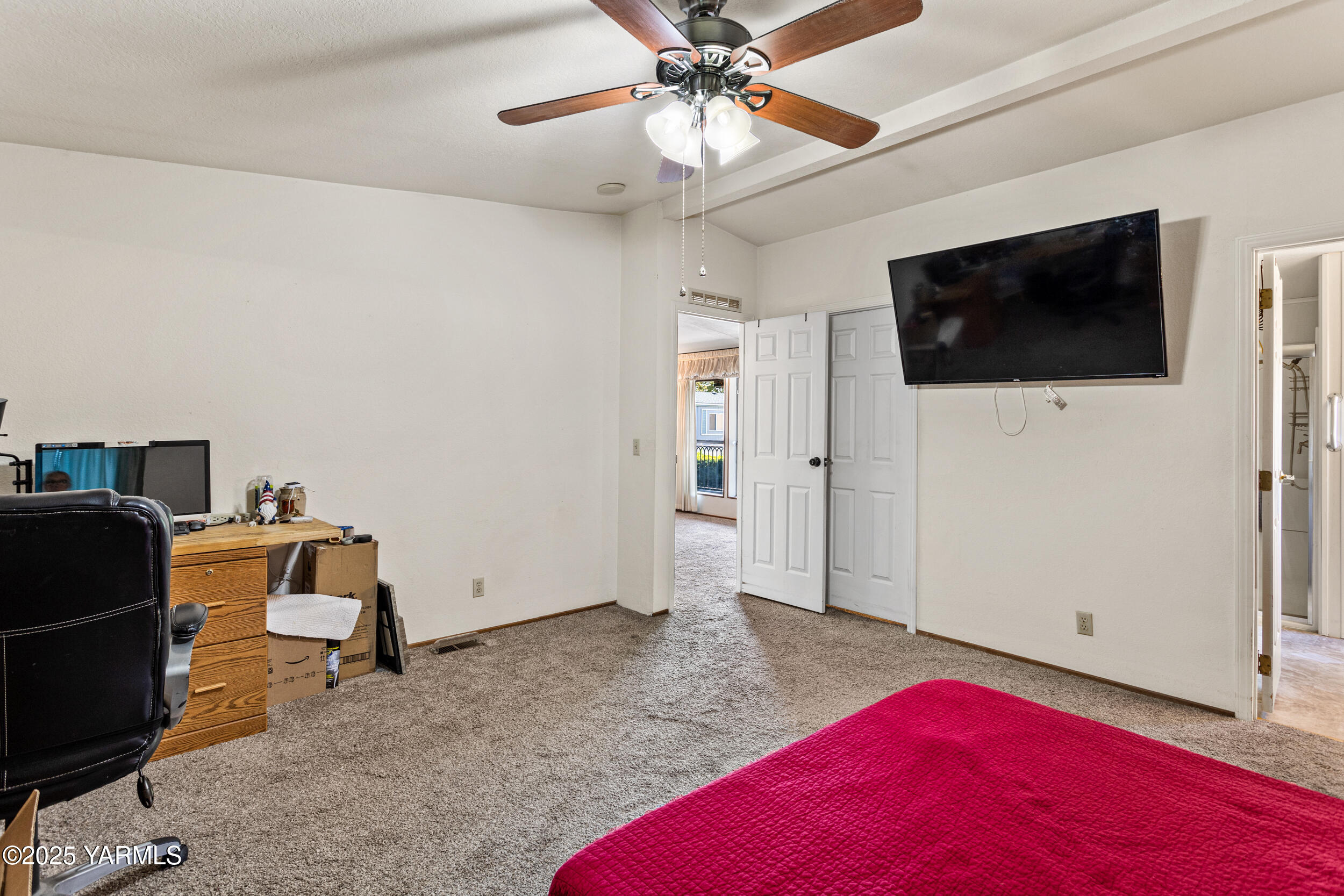 3701 Gun Club Road, Unit 64 Yakima, WA 98901 - Photo 14 of 30 a bedroom with a bed and a chandelier