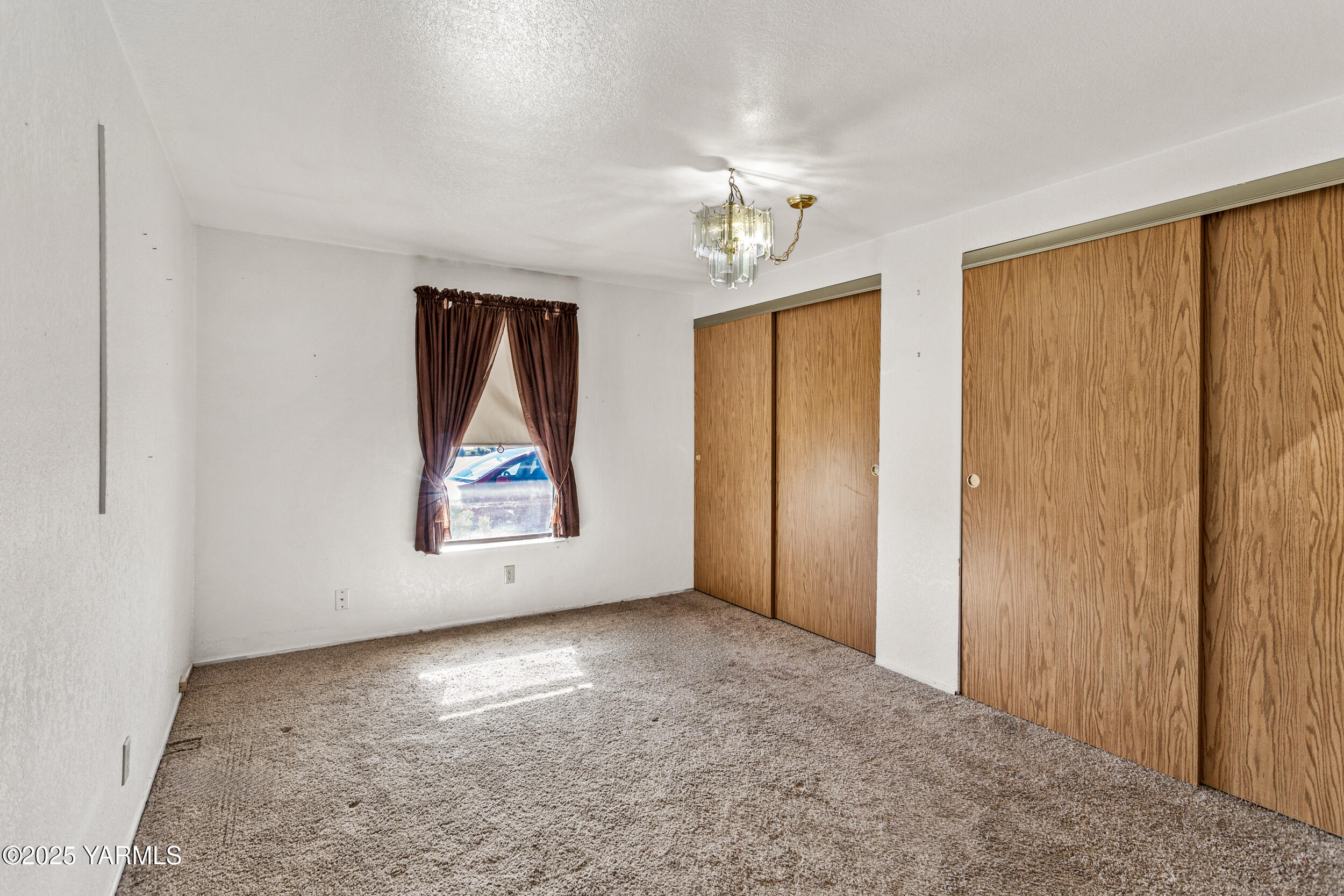3701 Gun Club Road, Unit 64 Yakima, WA 98901 - Photo 17 of 30 an empty room with windows and closet