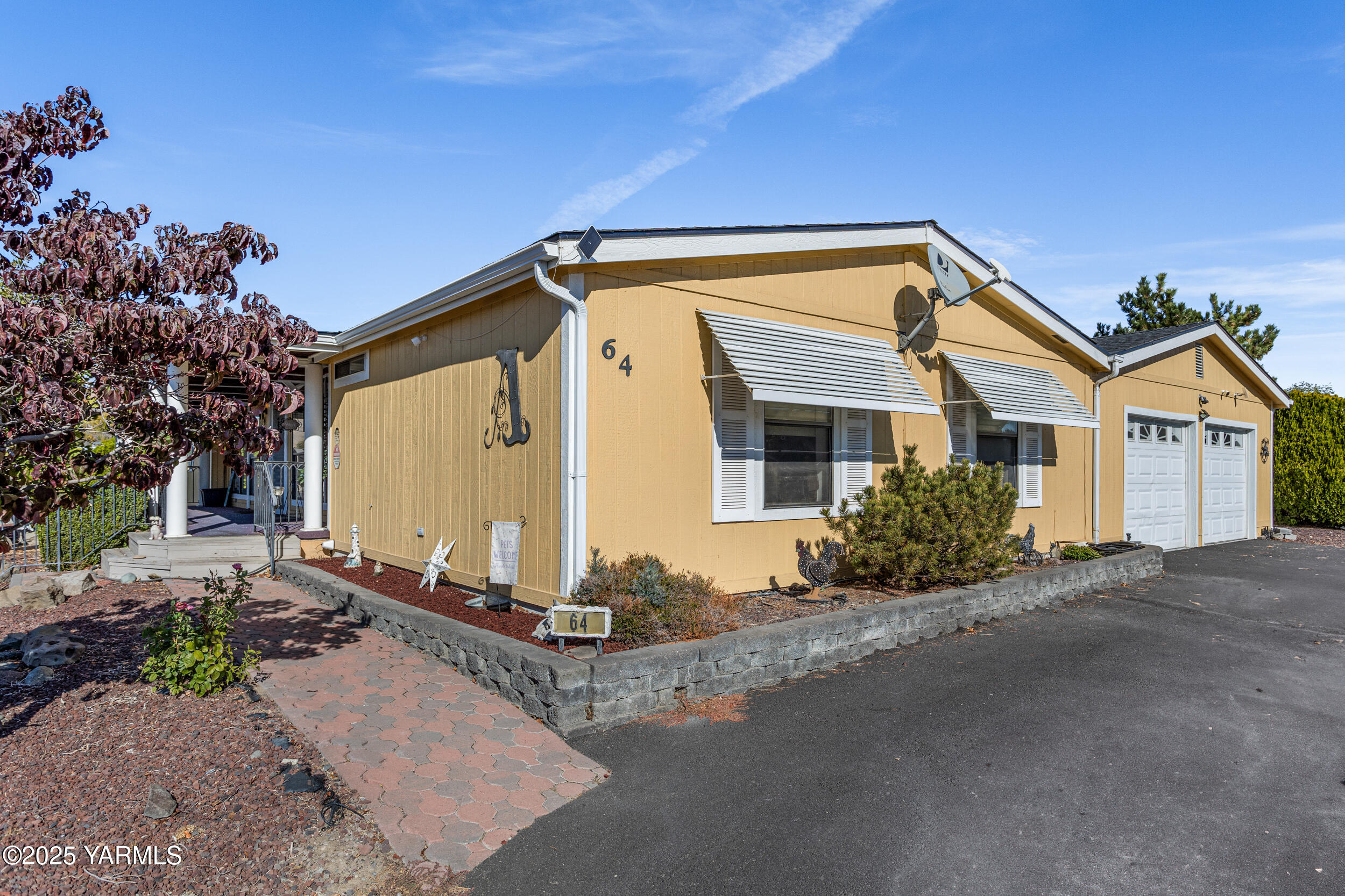 3701 Gun Club Road, Unit 64 Yakima, WA 98901 - Photo 2 of 30 a front view of a house with a yard