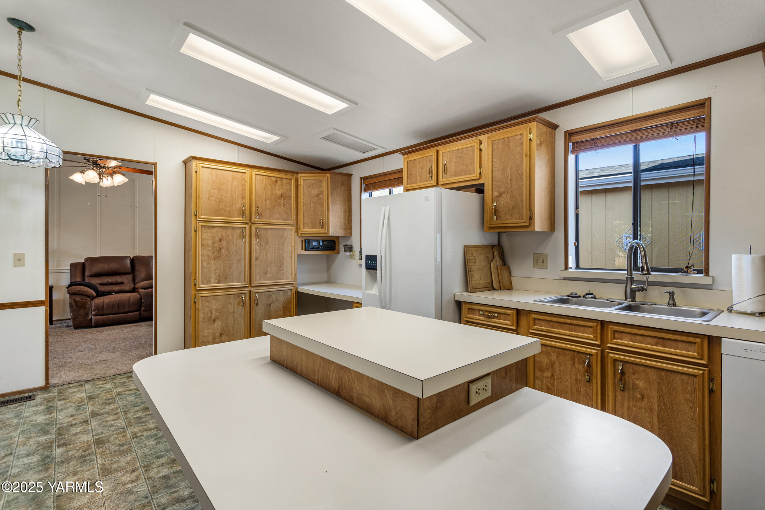 3701 Gun Club Road, Unit 64 Yakima, WA 98901 - Photo 9 of 30 a large white kitchen with a large window and refrigerator