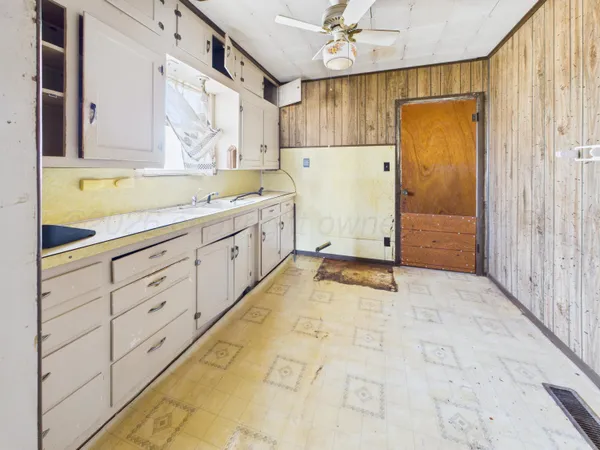 a view of a kitchen with white cabinets