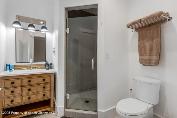 a bathroom with a toilet a sink and shower