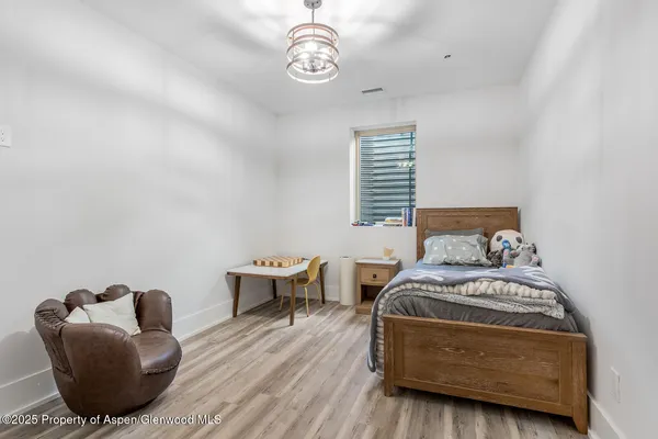 a bedroom with furniture and a window