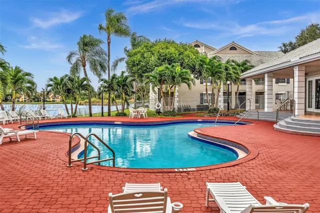 a view of swimming pool with outdoor seating and deck